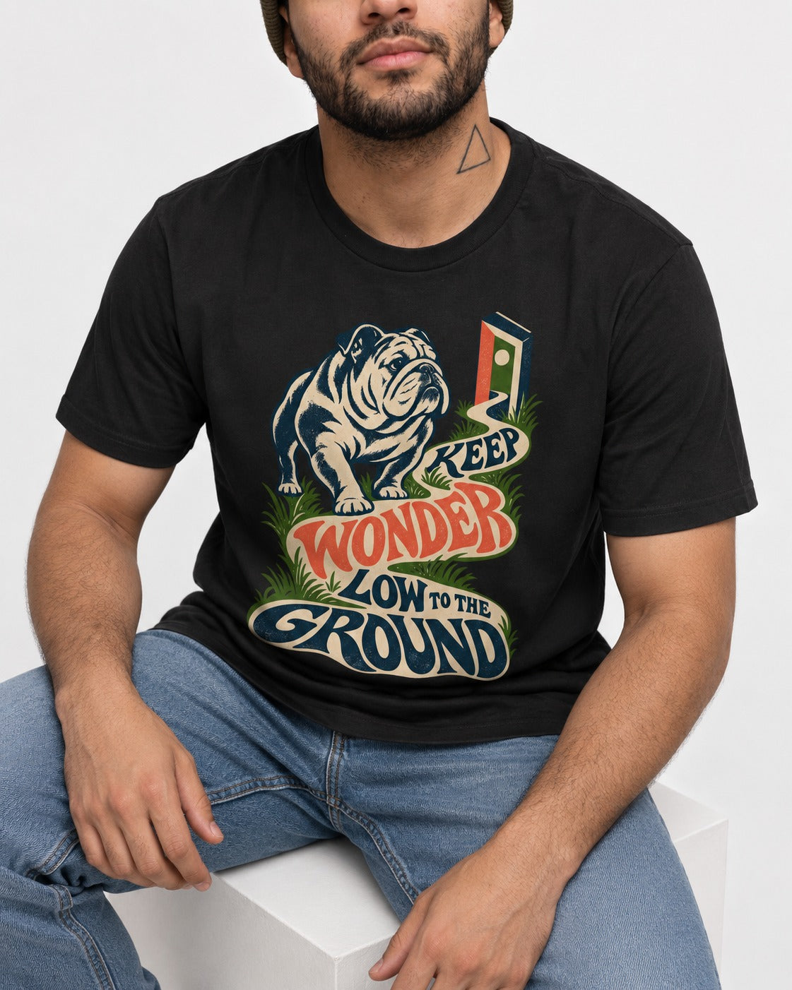 Keep Wonder Low to the Ground English Bulldog Graphic T-Shirt in Black, worn by a seated model