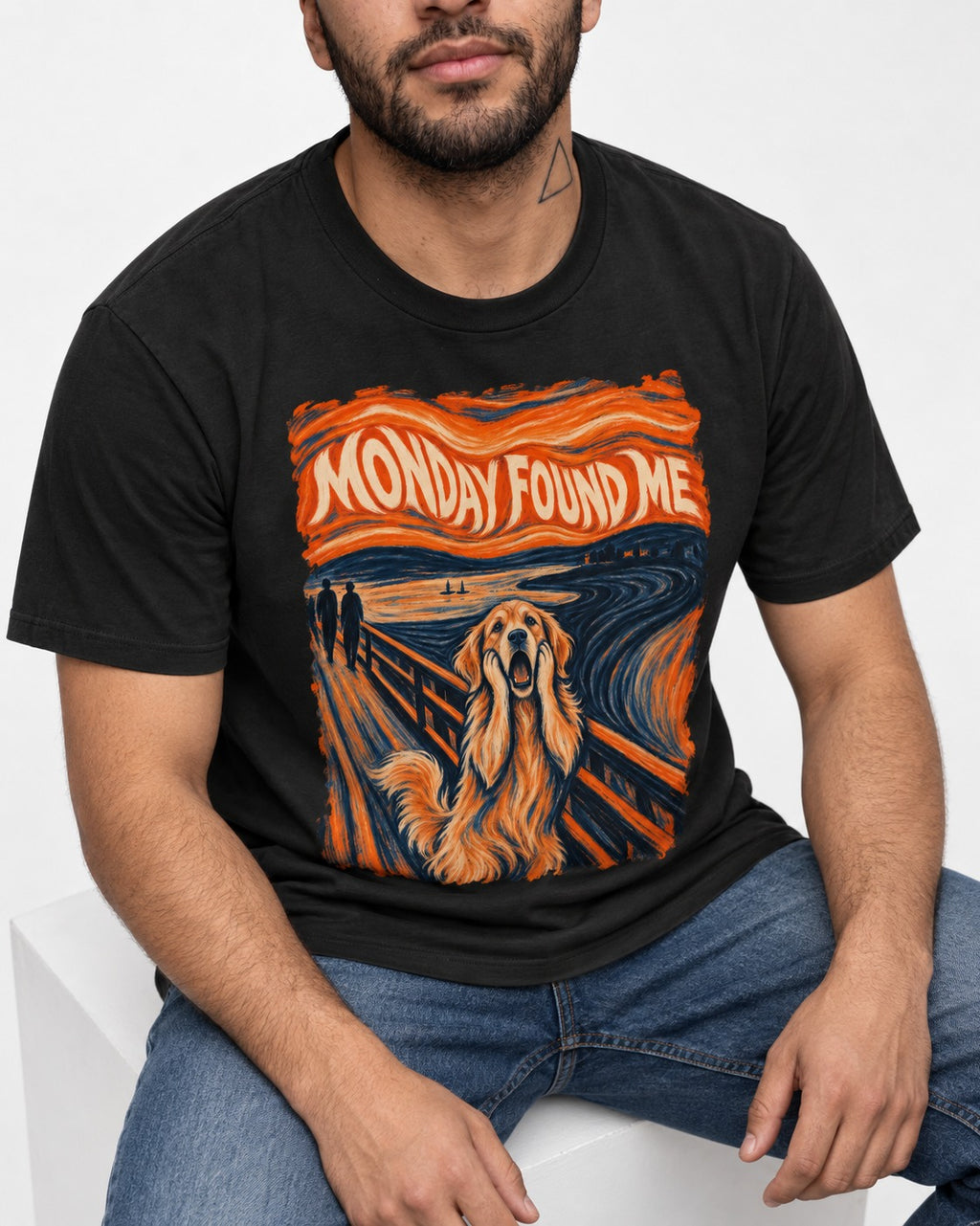 Monday Found Me Scream Golden Retriever Graphic T-Shirt in Black, worn by a seated model