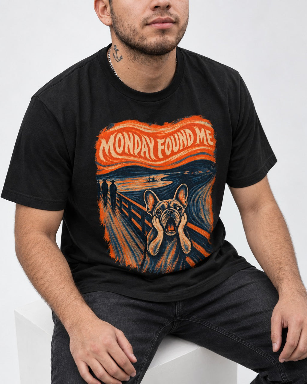 Frenchie Monday Found Me Scream Graphic 194 T-Shirt in Black, worn by a seated model