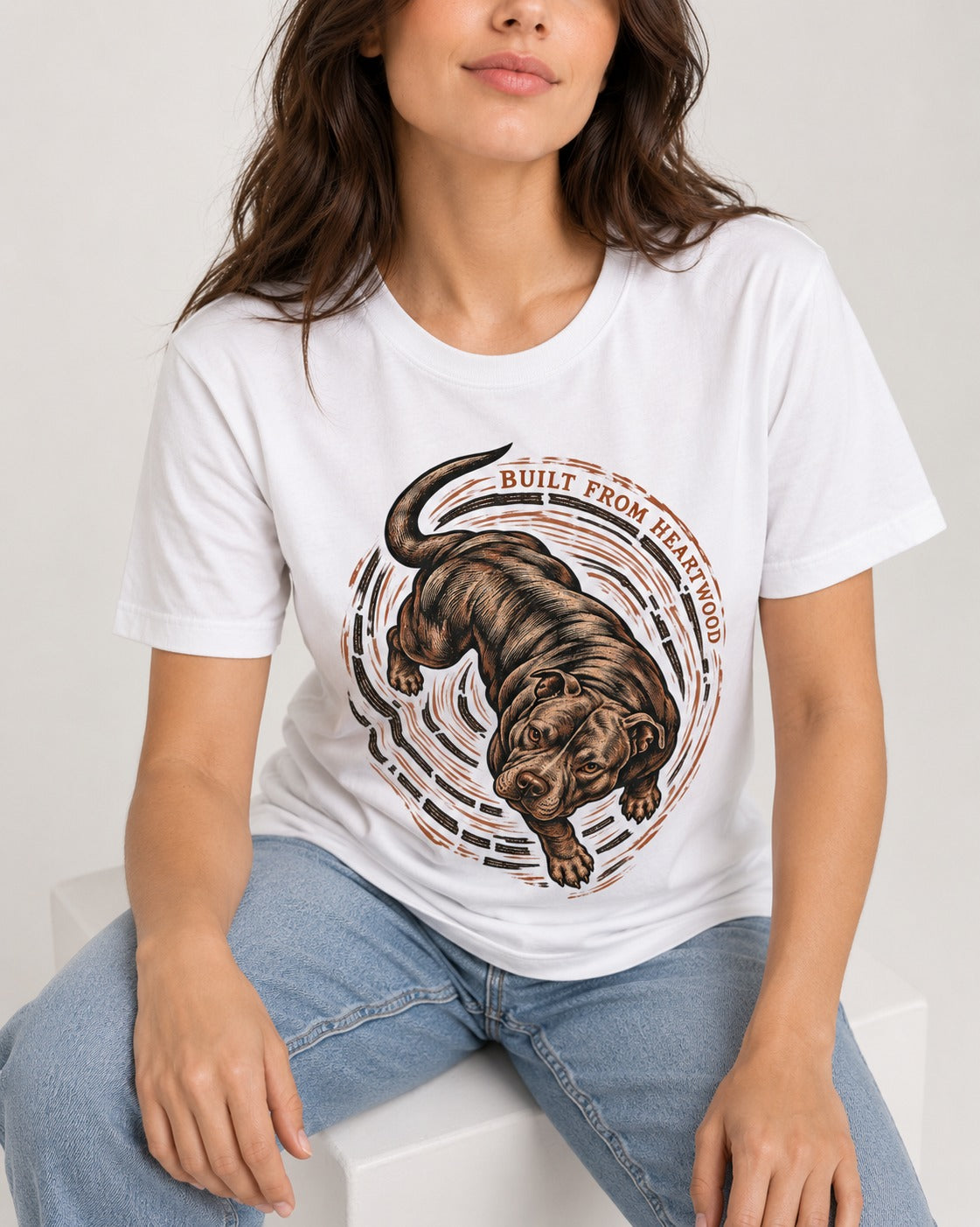 Pitbull Built From Heartwood T-Shirt in White, worn by a seated model