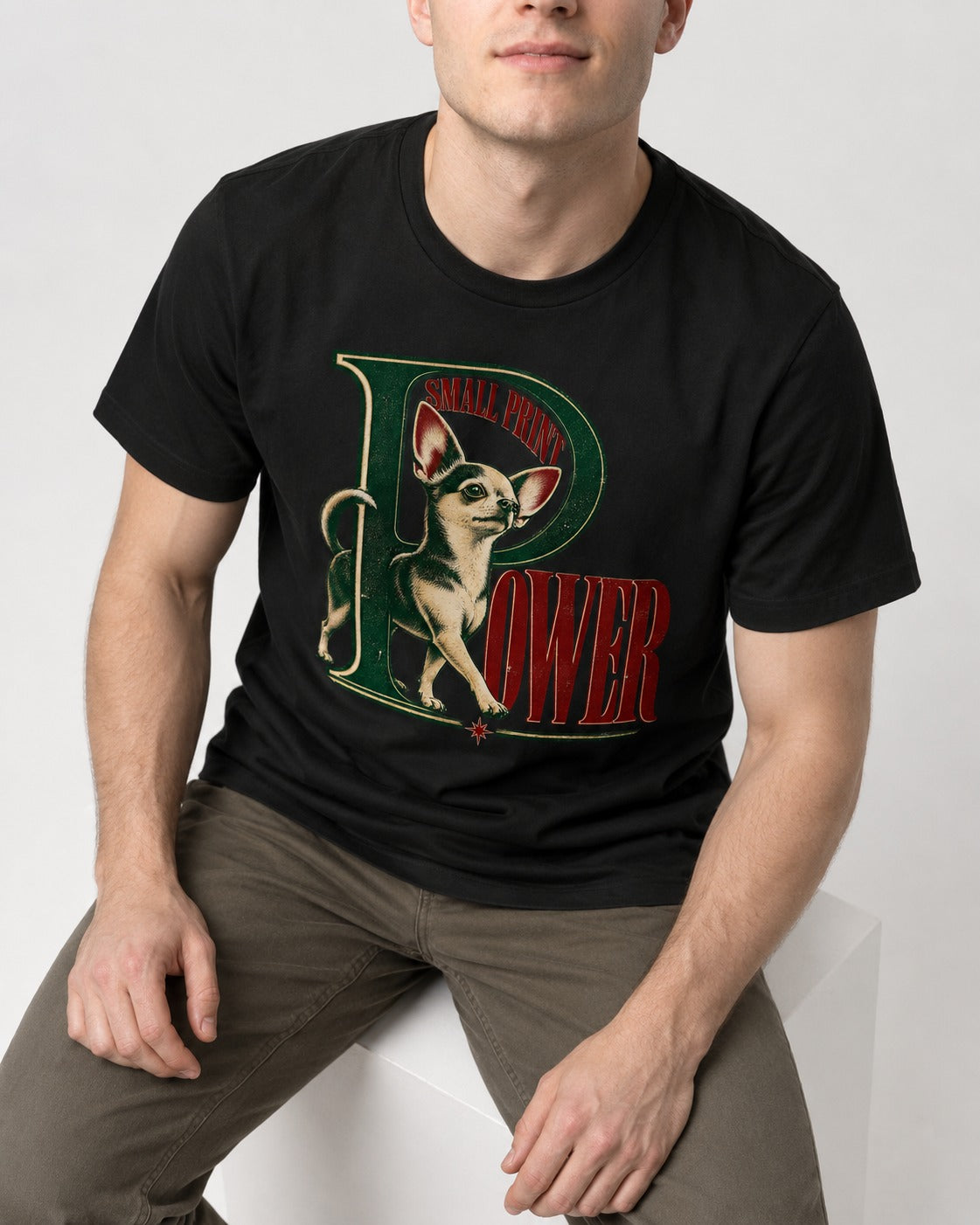 Chihuahua Small Print Power Monogram Graphic T-Shirt in Black, worn by a seated model