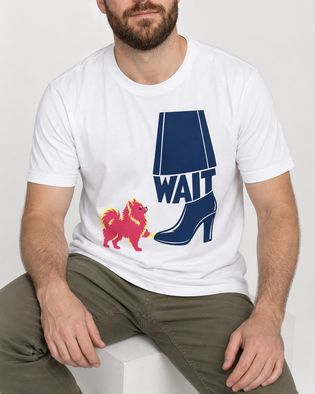 Pomeranian Says Wait T-Shirt in White, worn by a seated model