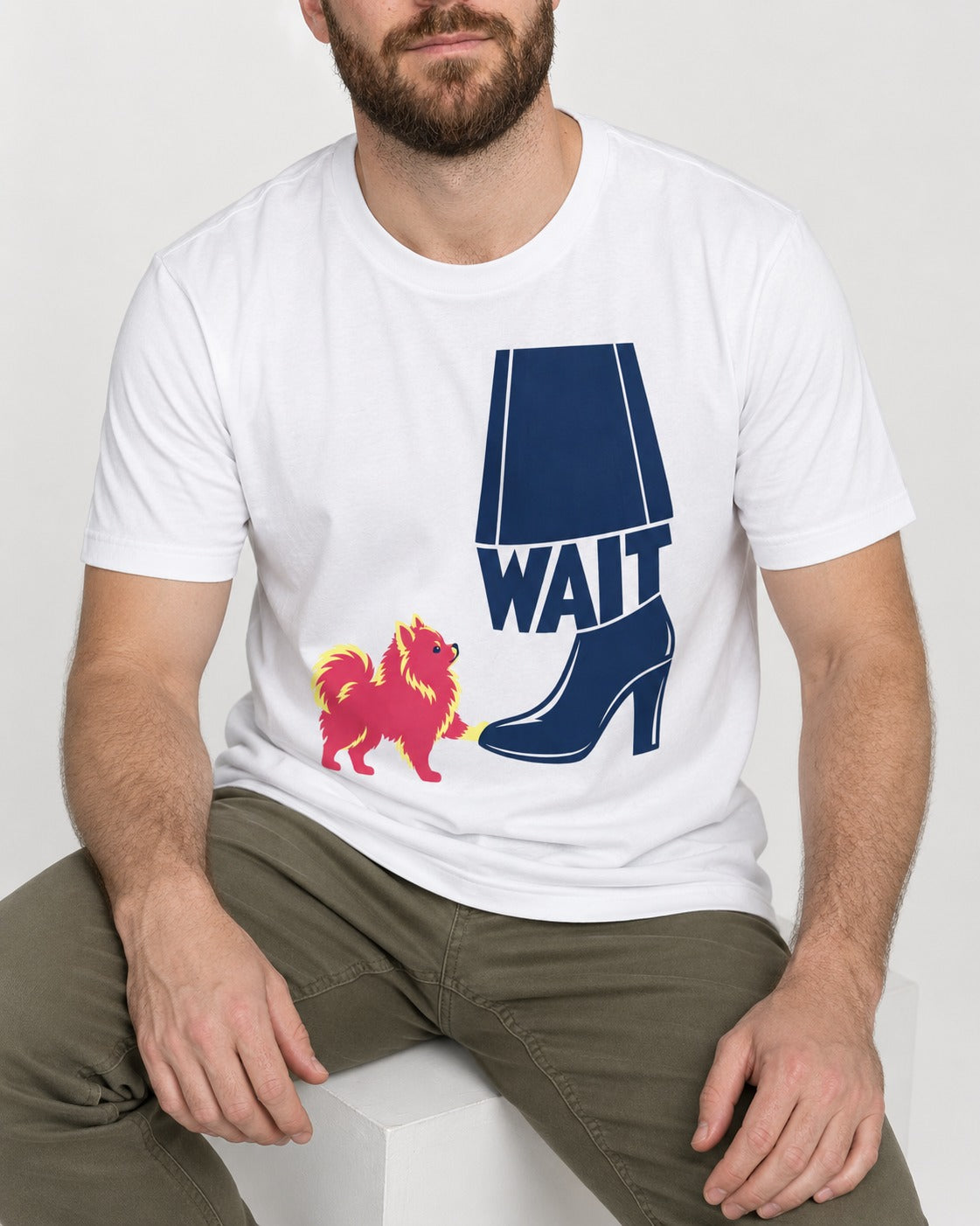 Pomeranian Says Wait T-Shirt in White, worn by a seated model