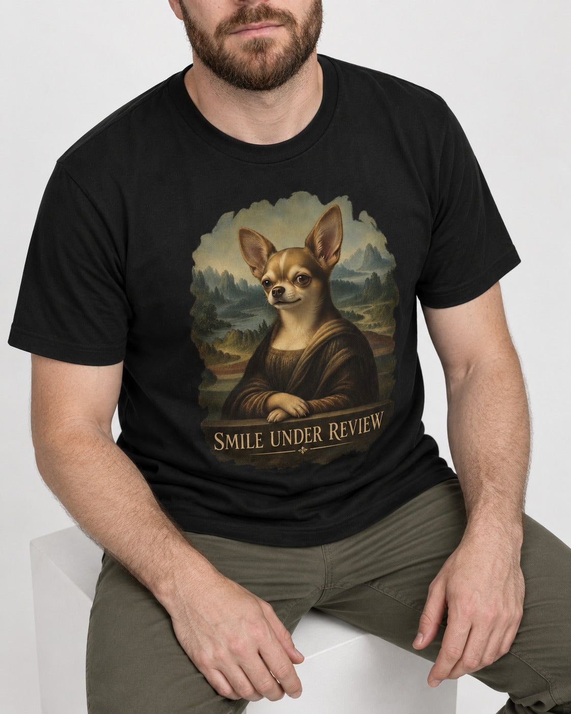 Chihuahua Smile Under Review Mona Lisa Portrait T-Shirt in Black, worn by a seated model