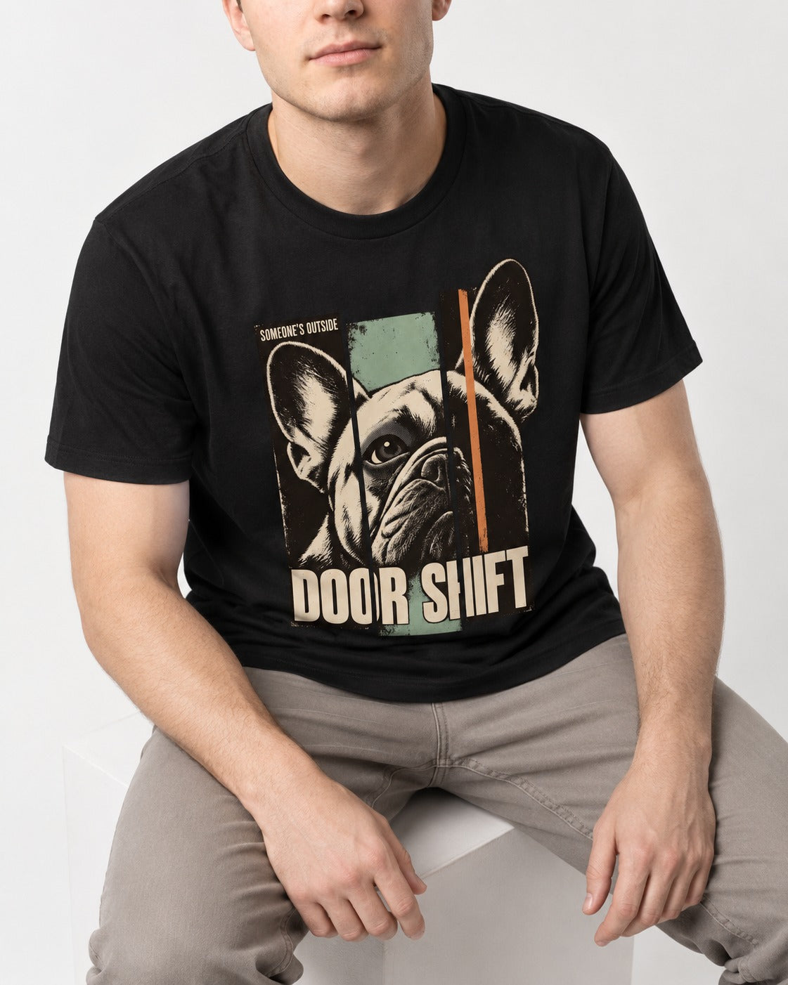 Frenchie Someone's Outside Door Shift Graphic T-Shirt in Black, worn by a seated model