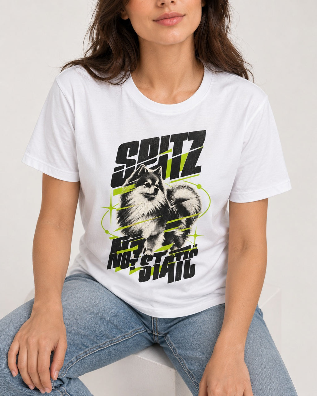 Pomeranian Not Static T-Shirt in White, worn by a seated model