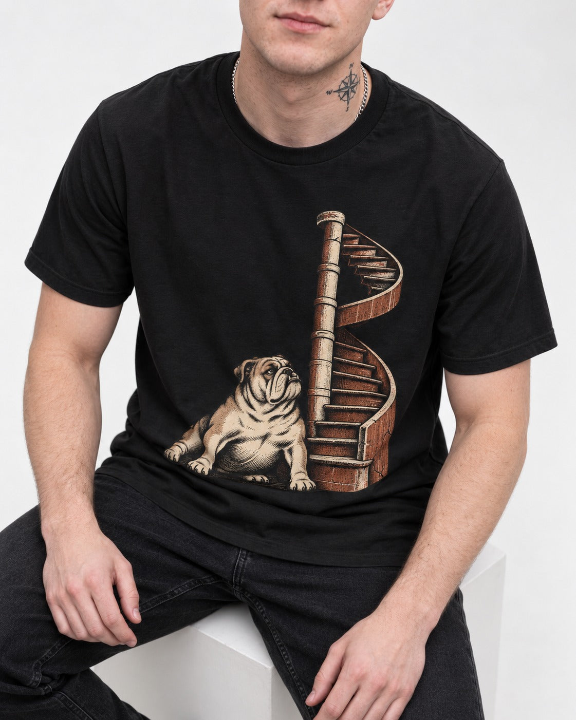 English Bulldog Spiral Staircase Graphic T-Shirt in Black, worn by a seated model