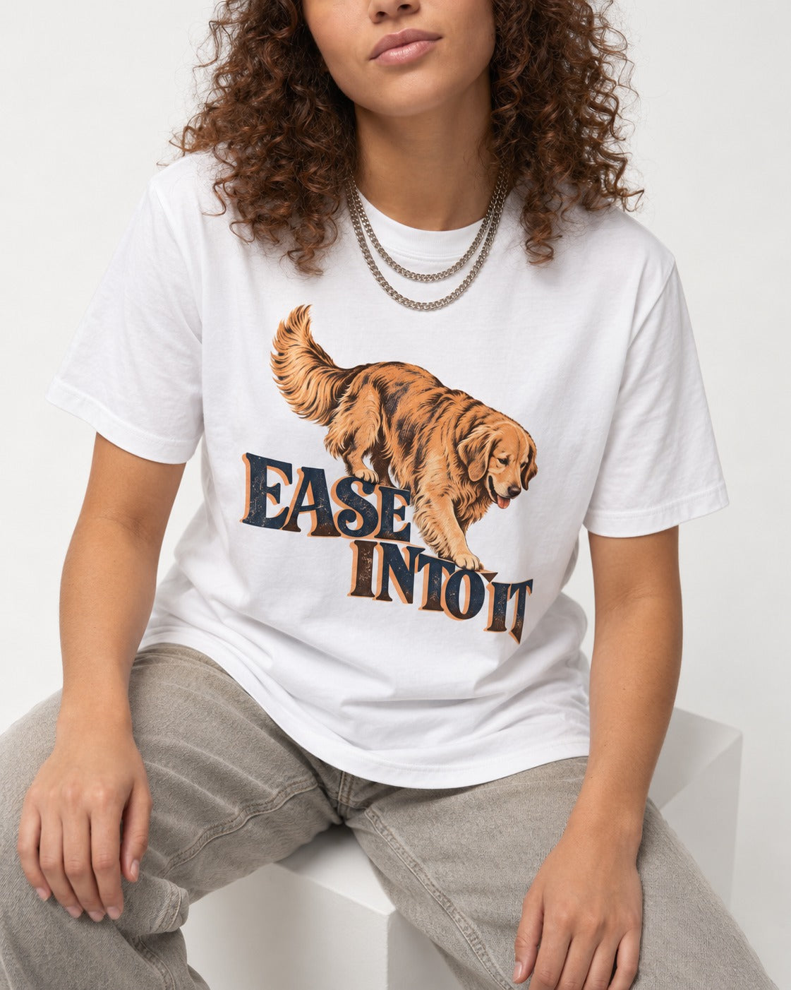 Golden Retriever Ease Into It T-Shirt in White, worn by a seated model