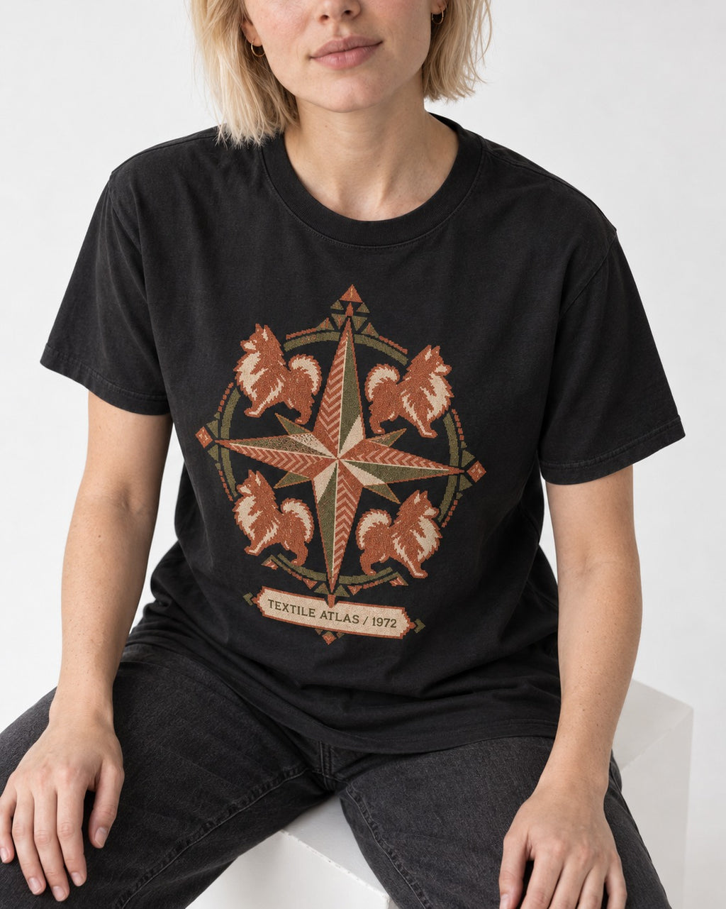 Pomeranian Textile Atlas Compass Rose Graphic T-Shirt in Black, worn by a seated model
