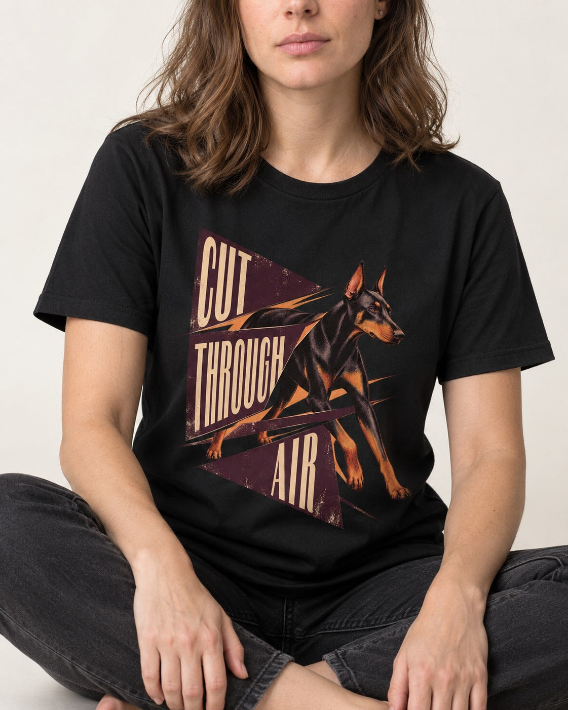 Doberman Cut Through Air Graphic T-Shirt in Black, worn by a seated model