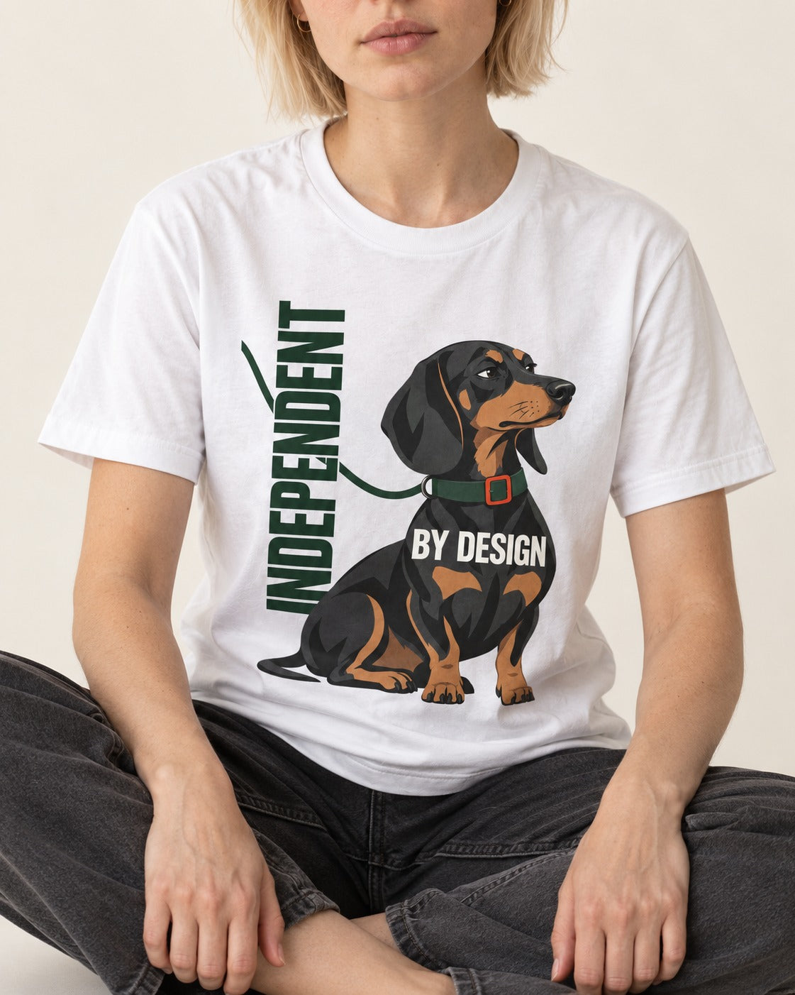 Independent Dachshund T-Shirt in White, worn by a seated model