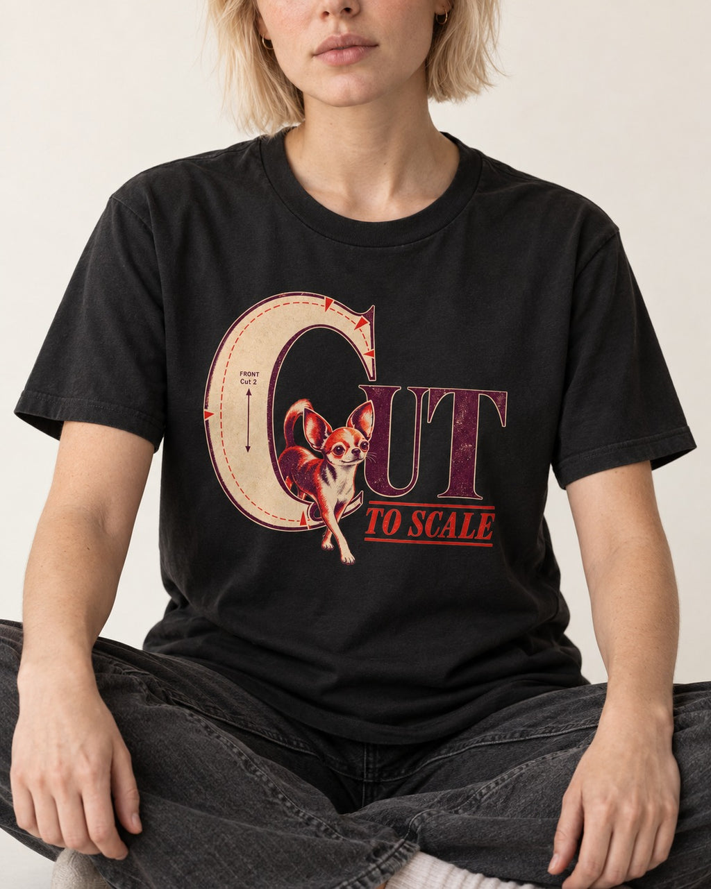 Chihuahua Cut to Scale Sewing Pattern Graphic T-Shirt in Black, worn by a seated model