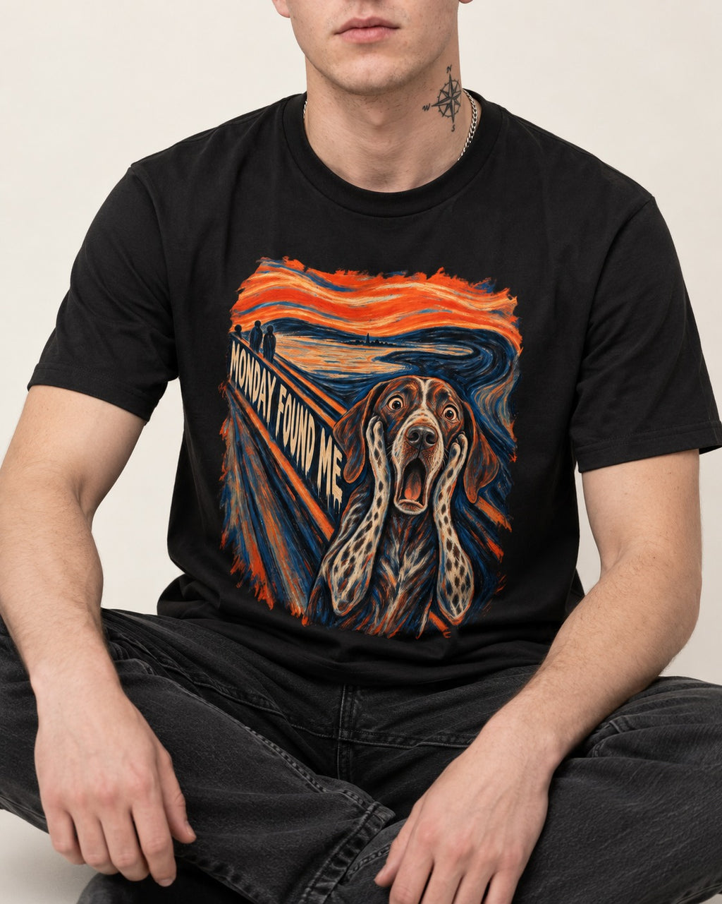German Shorthaired Pointer Monday Found Me Scream Parody Graphic T-Shirt in Black, worn by a seated model