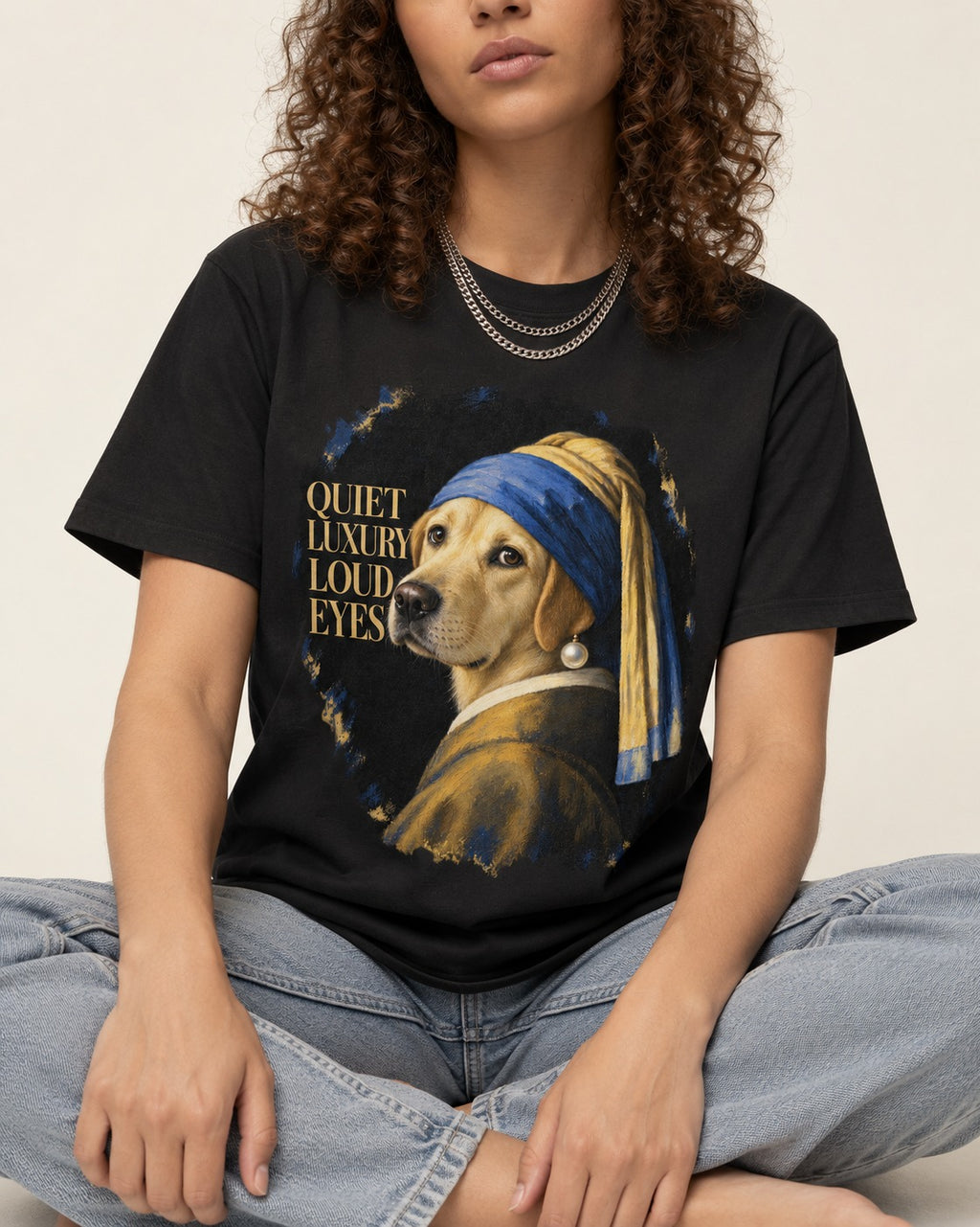 Labrador Retriever Quiet Luxury Loud Eyes Pearl Earring Graphic T-Shirt in Black, worn by a seated model