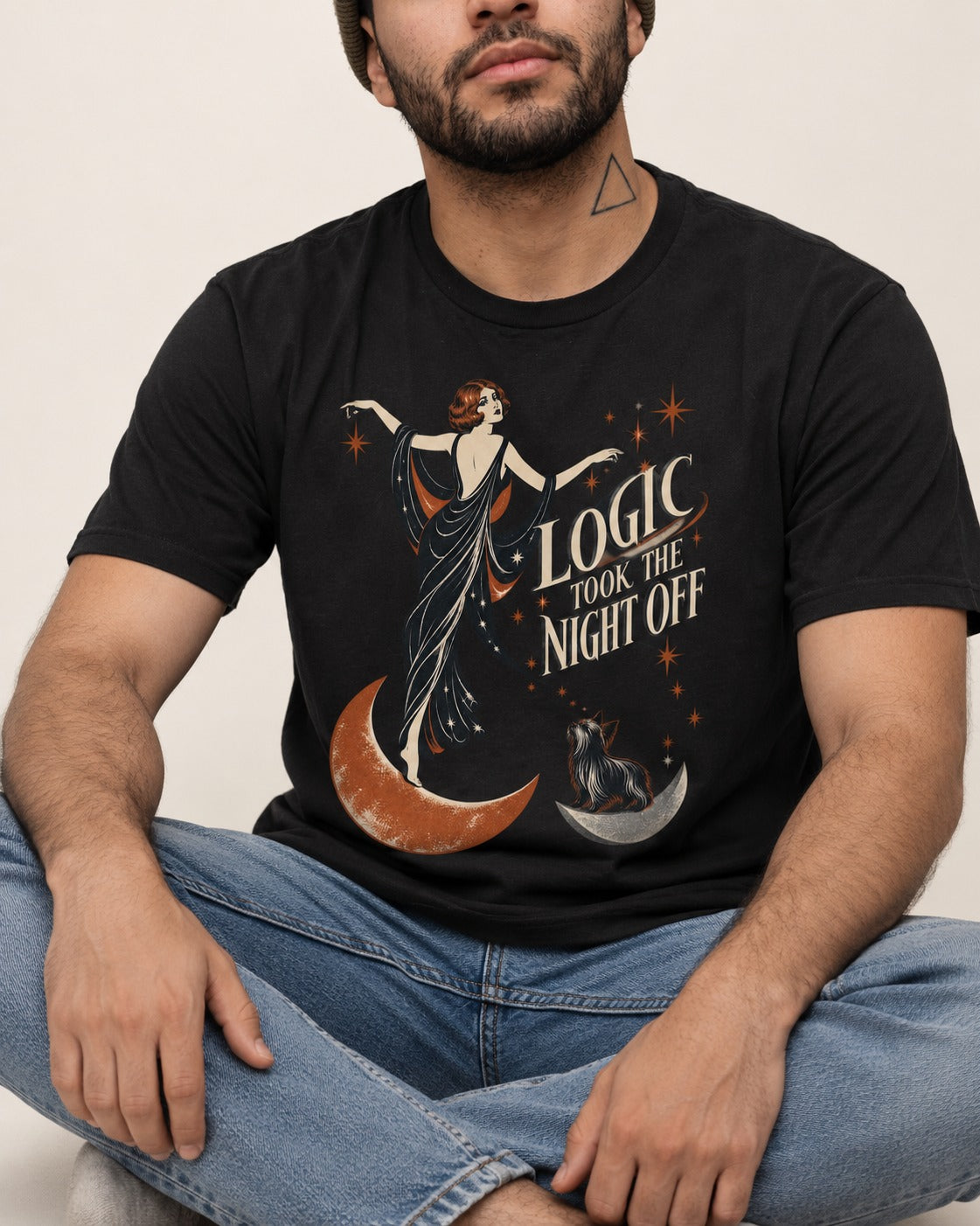 Yorkshire Terrier Logic Took the Night Off Art Deco Graphic T-Shirt in Black, worn by a seated model