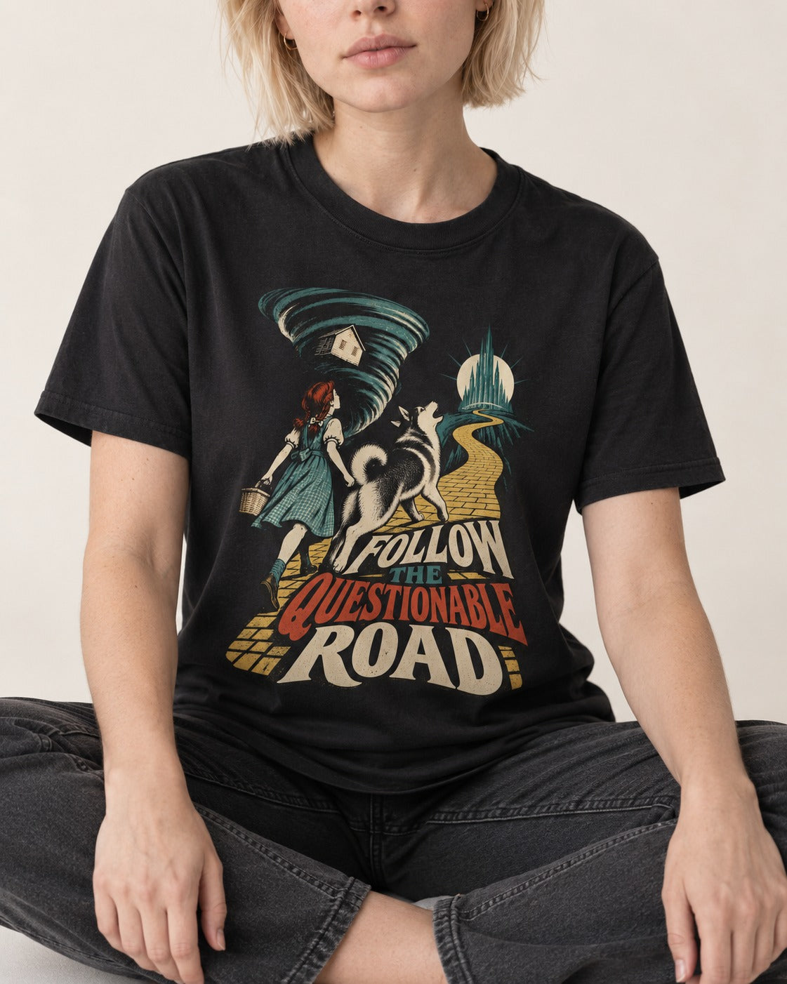 Husky Follow the Questionable Road Tornado Graphic T-Shirt in Black, worn by a seated model