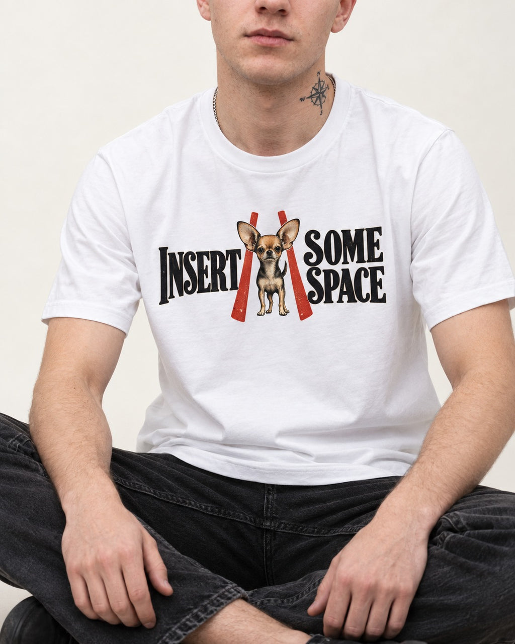 Insert Some Chihuahua Space T-Shirt in White, worn by a seated model