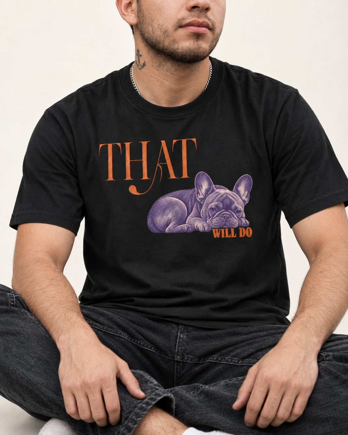 Frenchie That Will Do Resting Graphic T-Shirt in Black, worn by a seated model