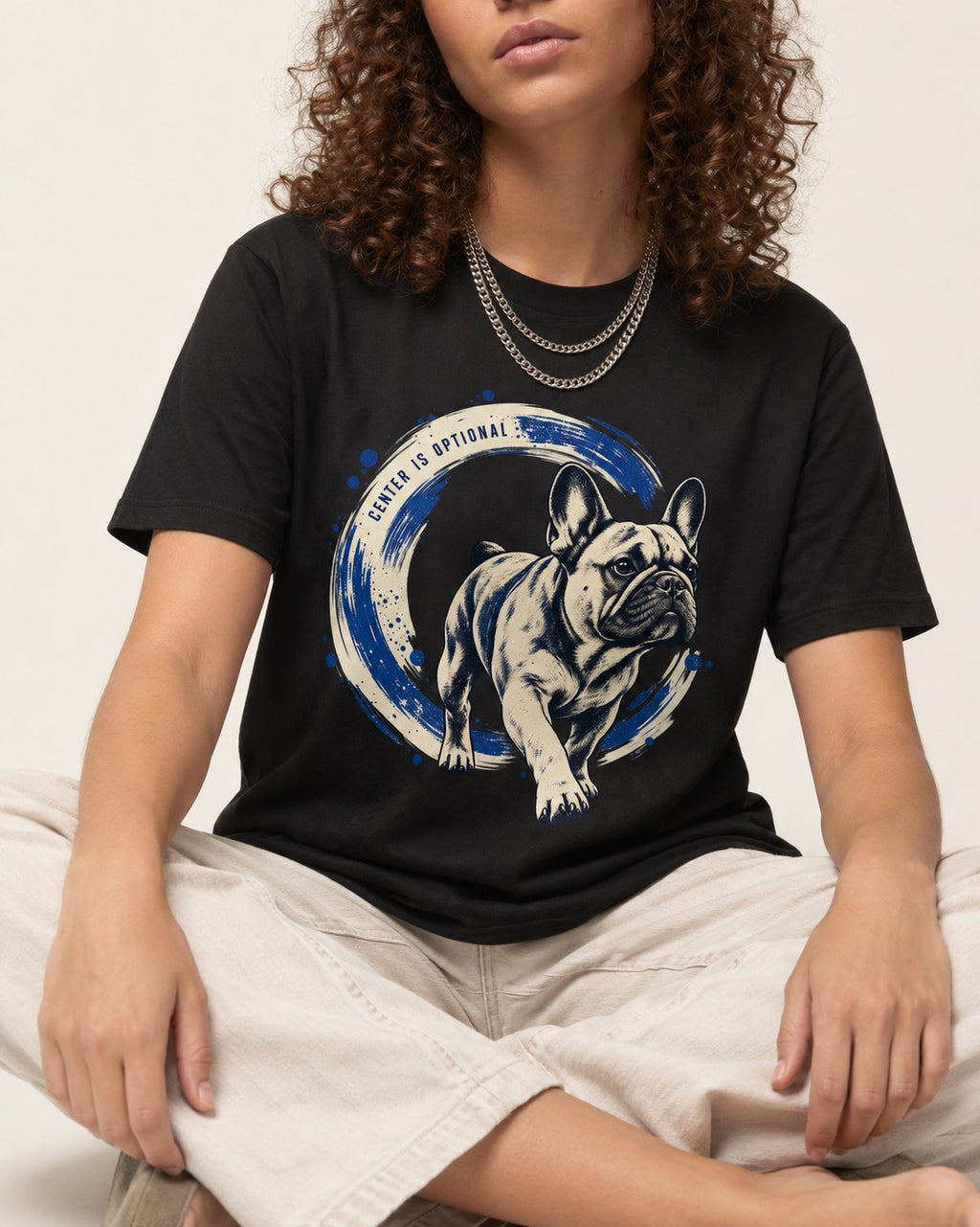 Frenchie Center Is Optional Brush Circle Graphic T-Shirt in Black, worn by a seated model
