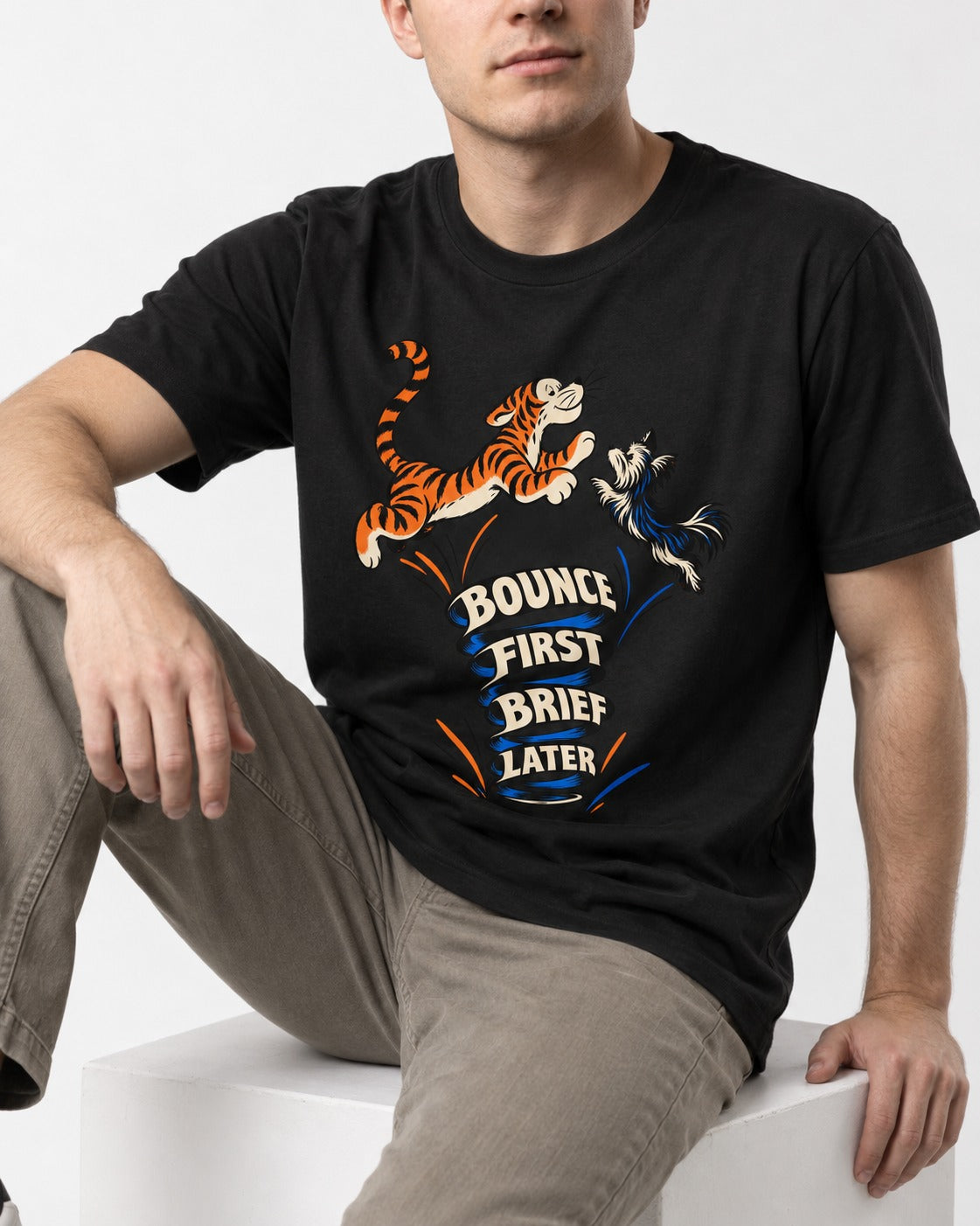 Yorkshire Terrier Bounce First Brief Later Tiger Graphic T-Shirt in Black, worn by a seated model