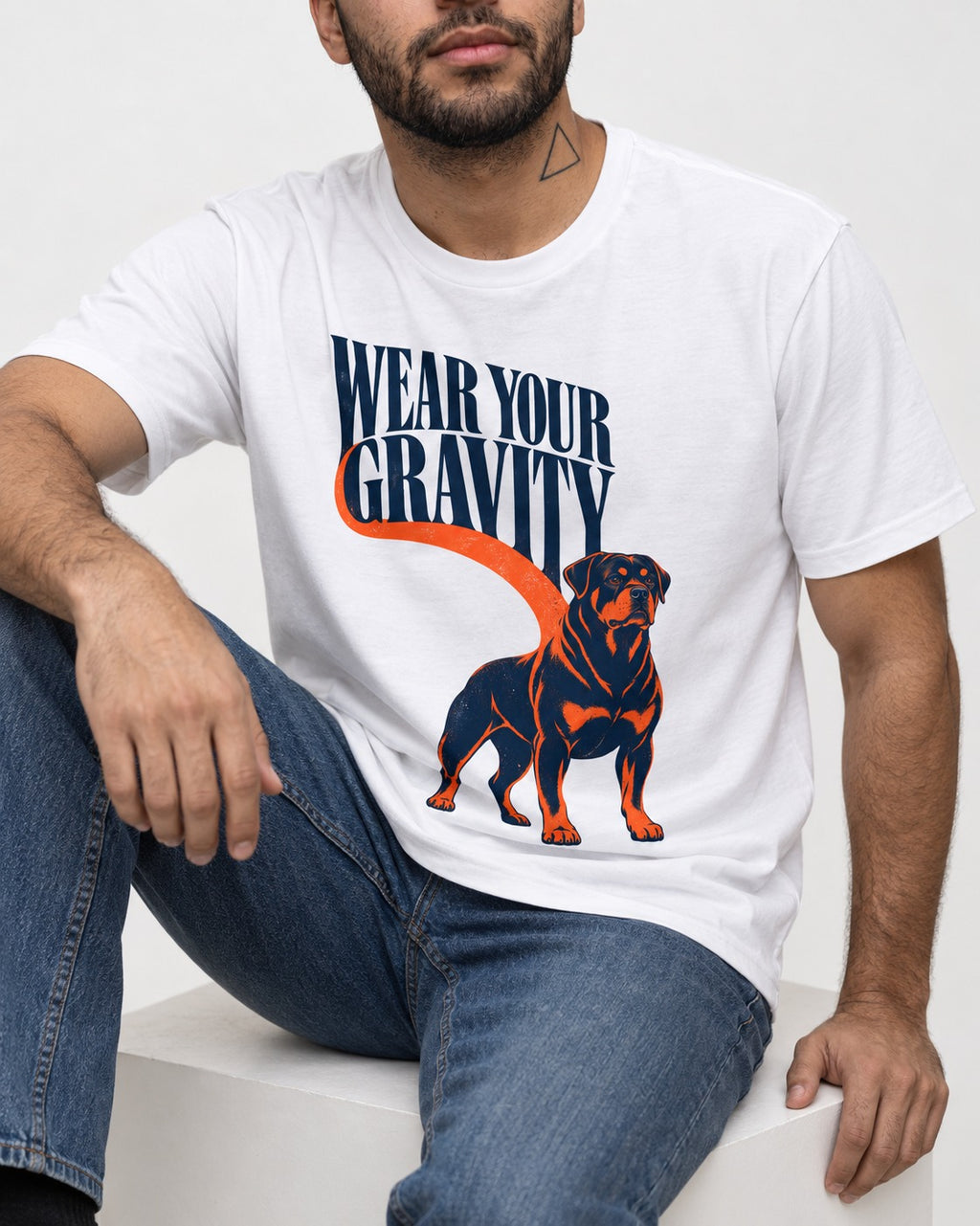 Wear Your Gravity Rottweiler T-Shirt in White, worn by a seated model