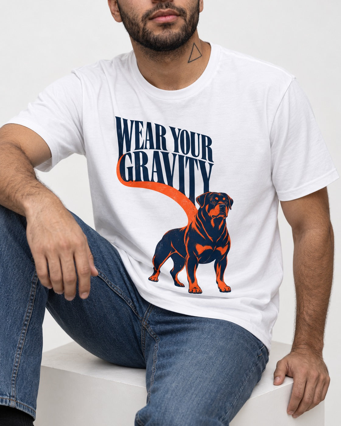 Wear Your Gravity Rottweiler T-Shirt in White, worn by a seated model