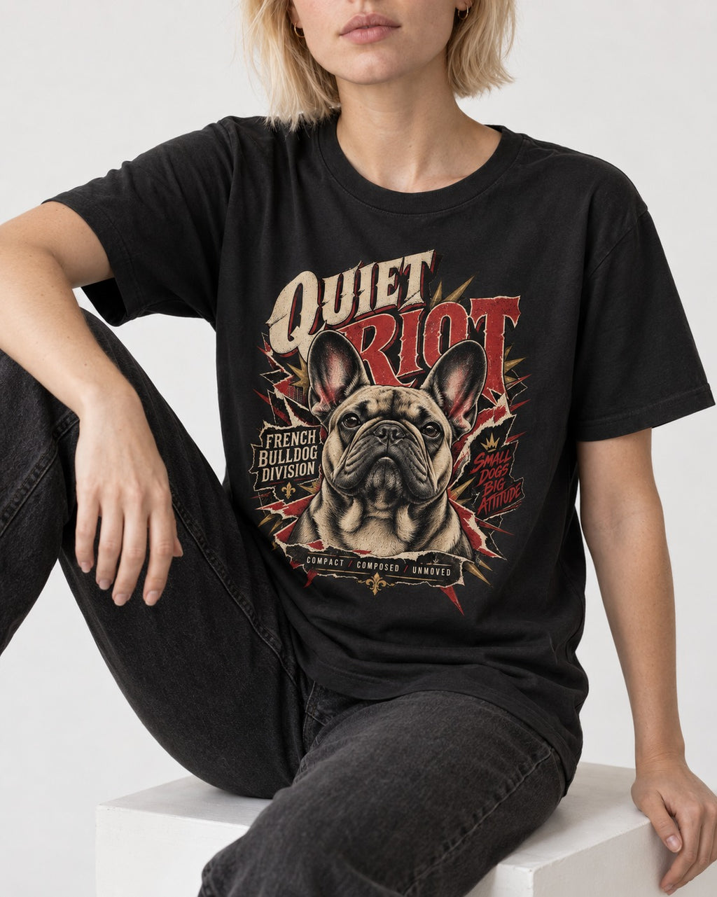 Frenchie Quiet Riot Division Emblem T-Shirt in Black, worn by a seated model
