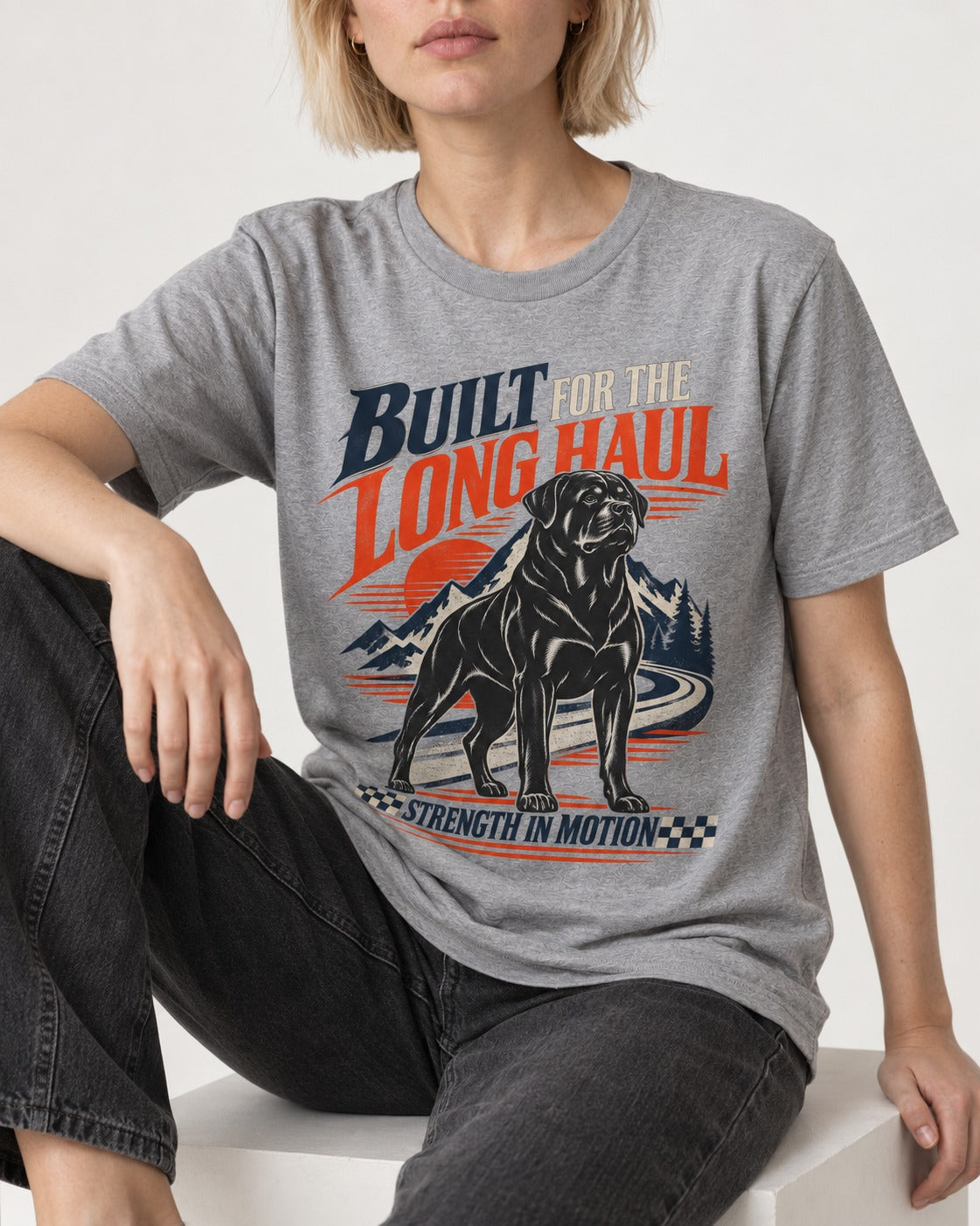 Built for the Long Haul Rottweiler Strength in Motion T-Shirt in Sport Grey, worn by a seated model