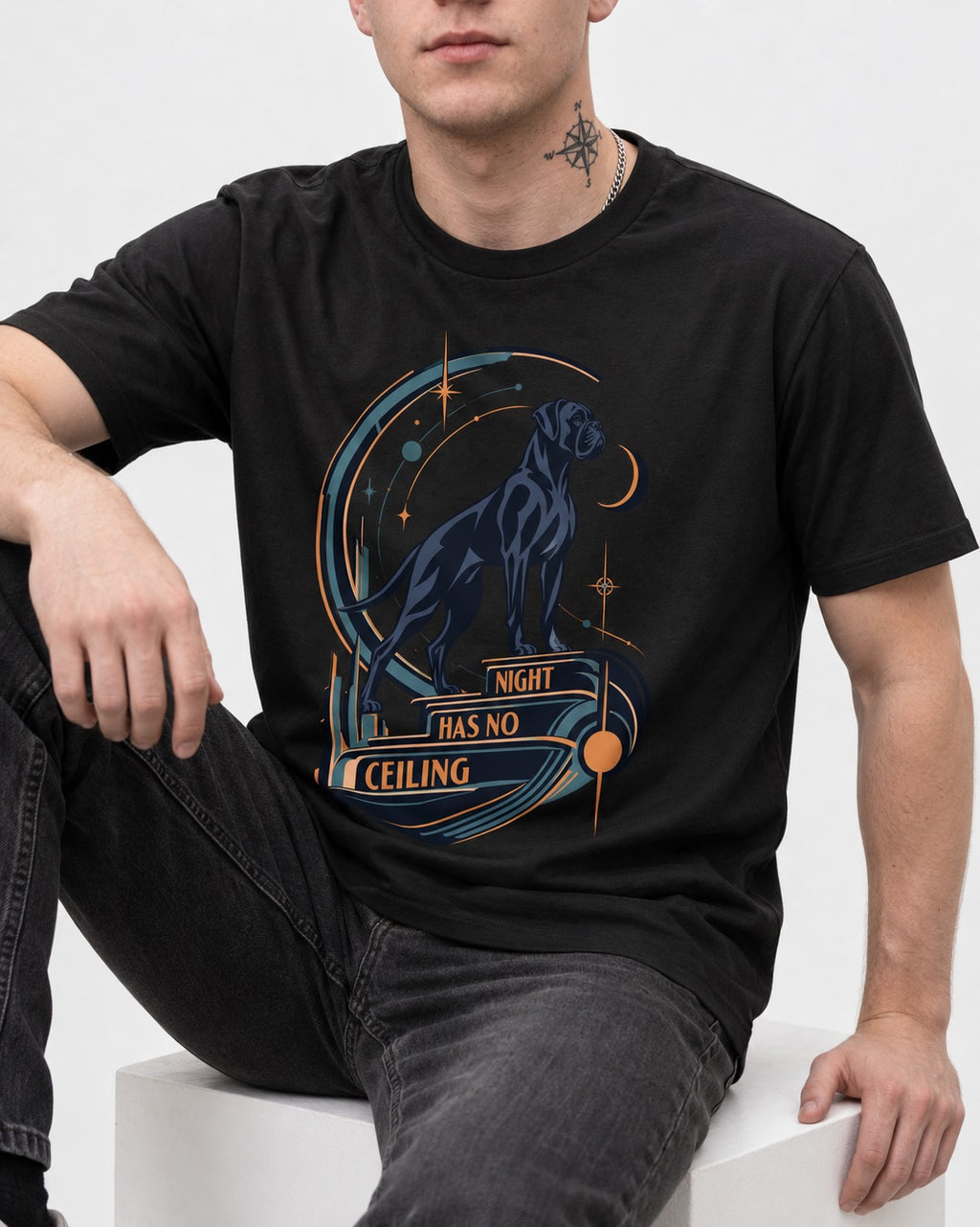 Night Has No Ceiling Boxer Cosmic Graphic T-Shirt in Black, worn by a seated model