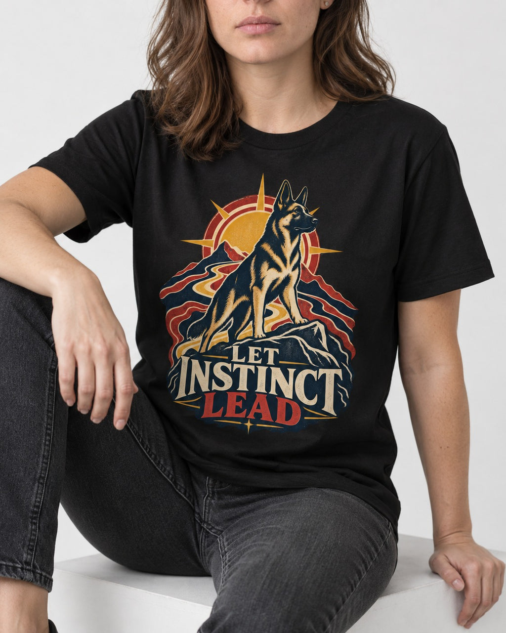 Let Instinct Lead Sunrise German Shepherd Dog Graphic T-Shirt in Black, worn by a seated model