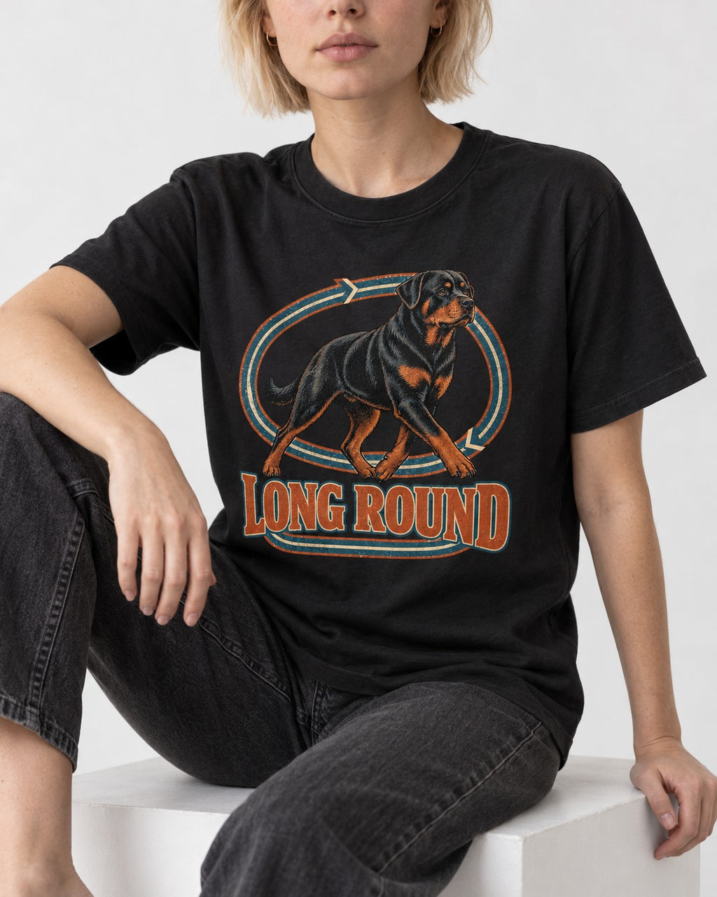 Rottweiler Long Round Circular Track Graphic T-Shirt in Black, worn by a seated model
