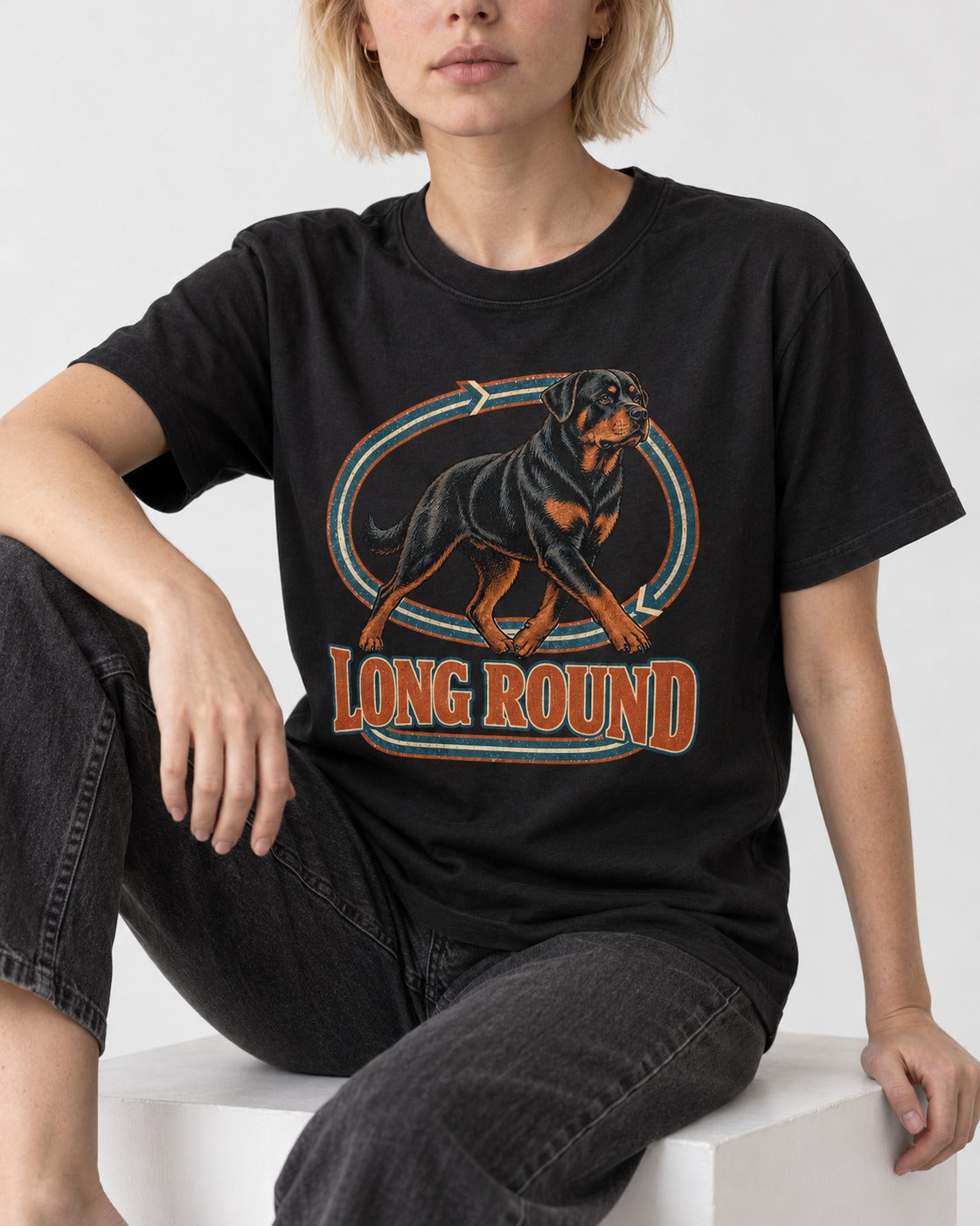 Rottweiler Long Round Circular Track Graphic T-Shirt in Black, worn by a seated model