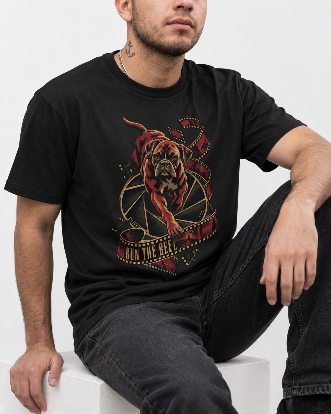 Run the Reel Boxer Film Graphic T-Shirt in Black, worn by a seated model