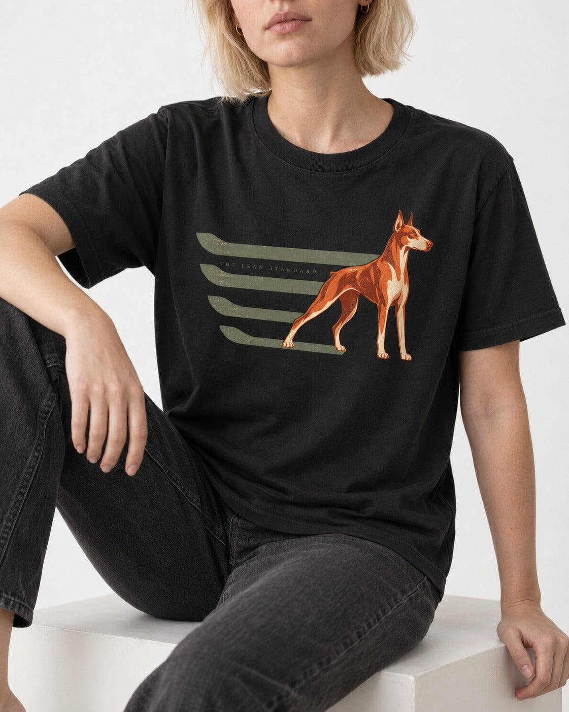 Doberman The Lean Standard Speed Bars Graphic T-Shirt in Black, worn by a seated model