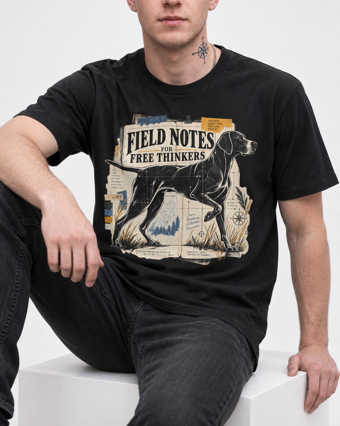 Field Notes for Free Thinkers Collage German Shorthaired Pointer Graphic T-Shirt in Black, worn by a seated model