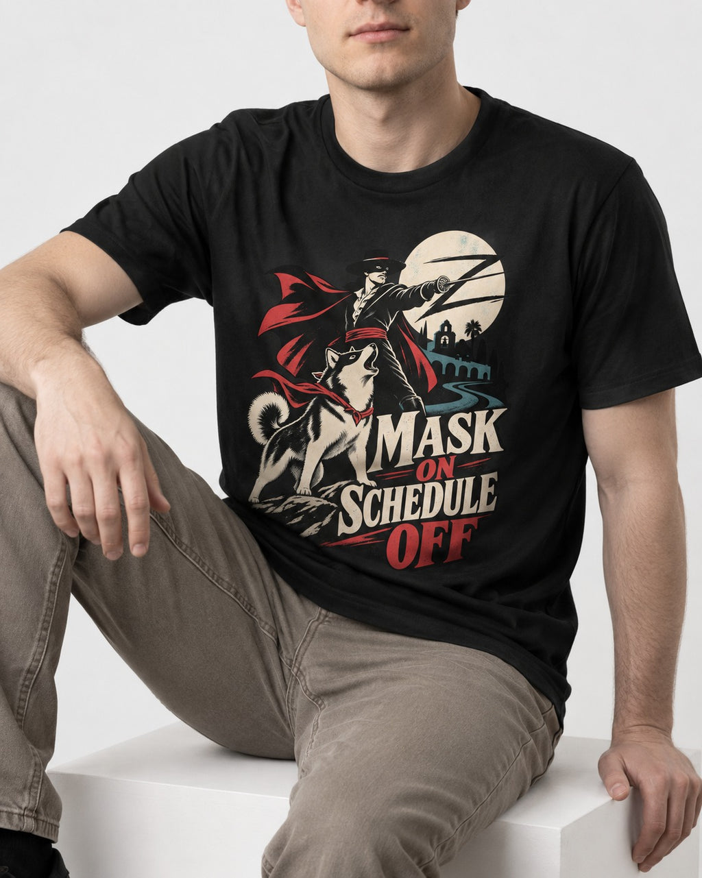 Husky Mask On Schedule Off Masked Swordsman Graphic T-Shirt in Black, worn by a seated model