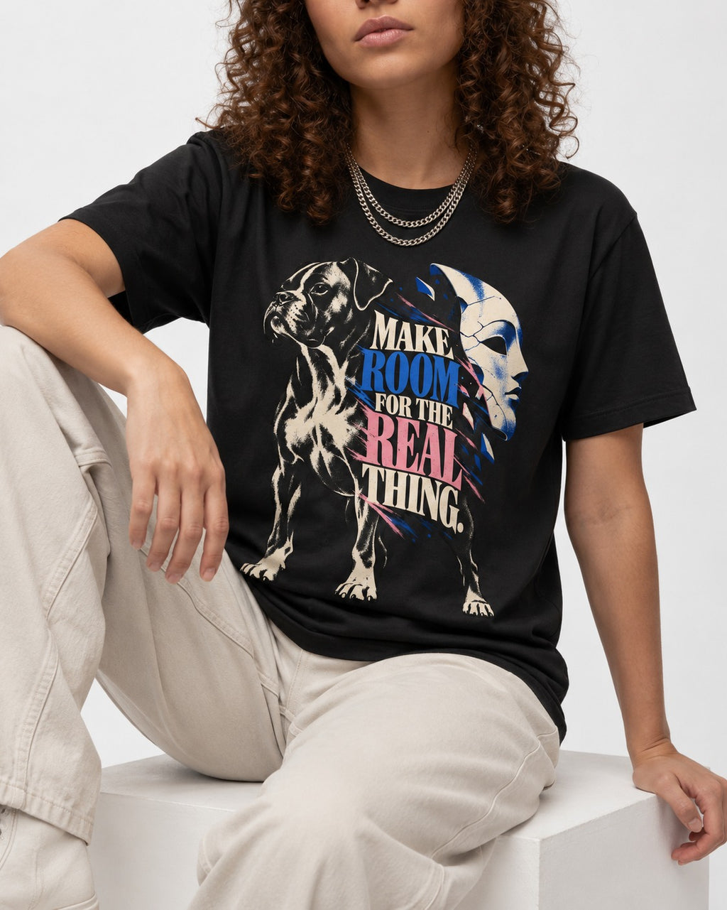 Make Room for the Real Thing Boxer Broken Mask Graphic T-Shirt in Black, worn by a seated model