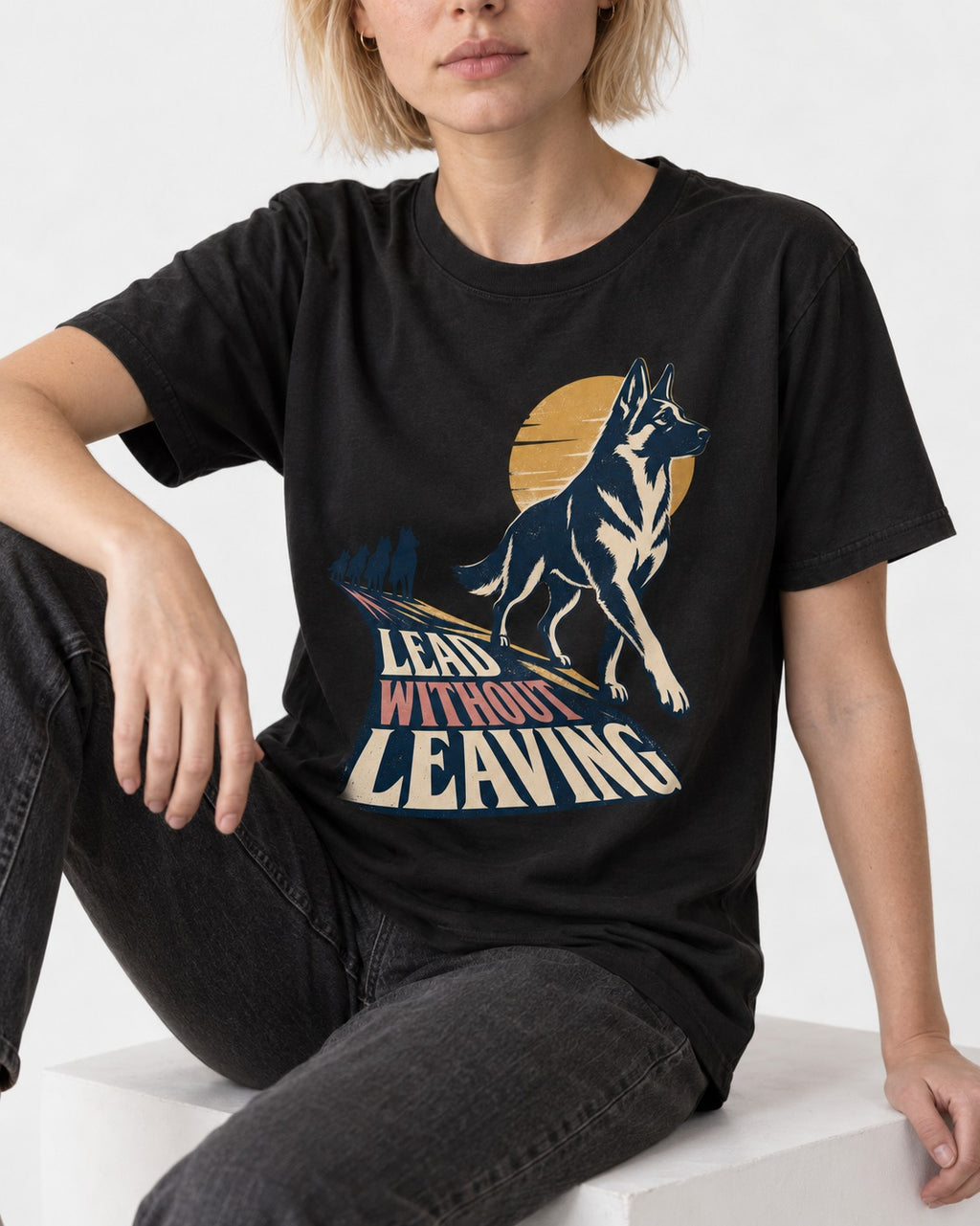 Lead Without Leaving Perspective German Shepherd Dog Graphic T-Shirt in Black, worn by a seated model