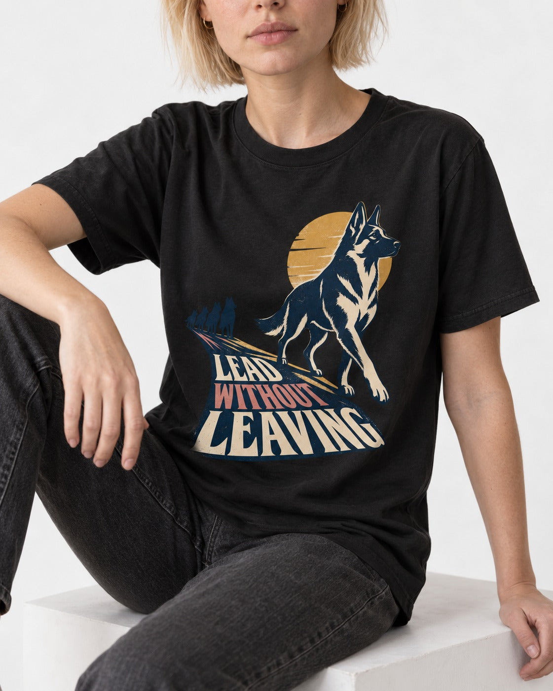 Lead Without Leaving Perspective German Shepherd Dog Graphic T-Shirt in Black, worn by a seated model