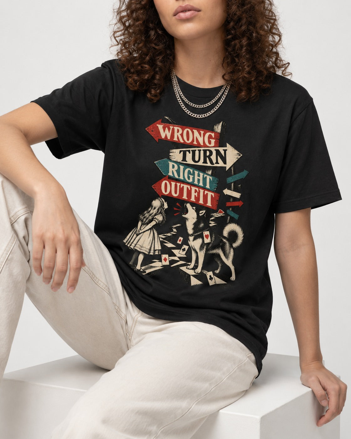 Husky Wrong Turn Right Outfit Wonderland Signpost Graphic T-Shirt in Black, worn by a seated model