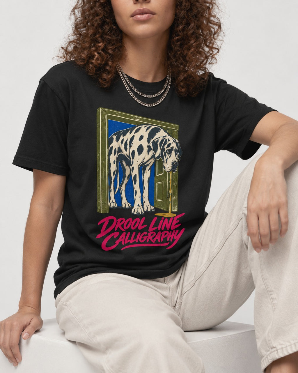 Great Dane Drool Line Calligraphy Doorway Graphic T-Shirt in Black, worn by a seated model