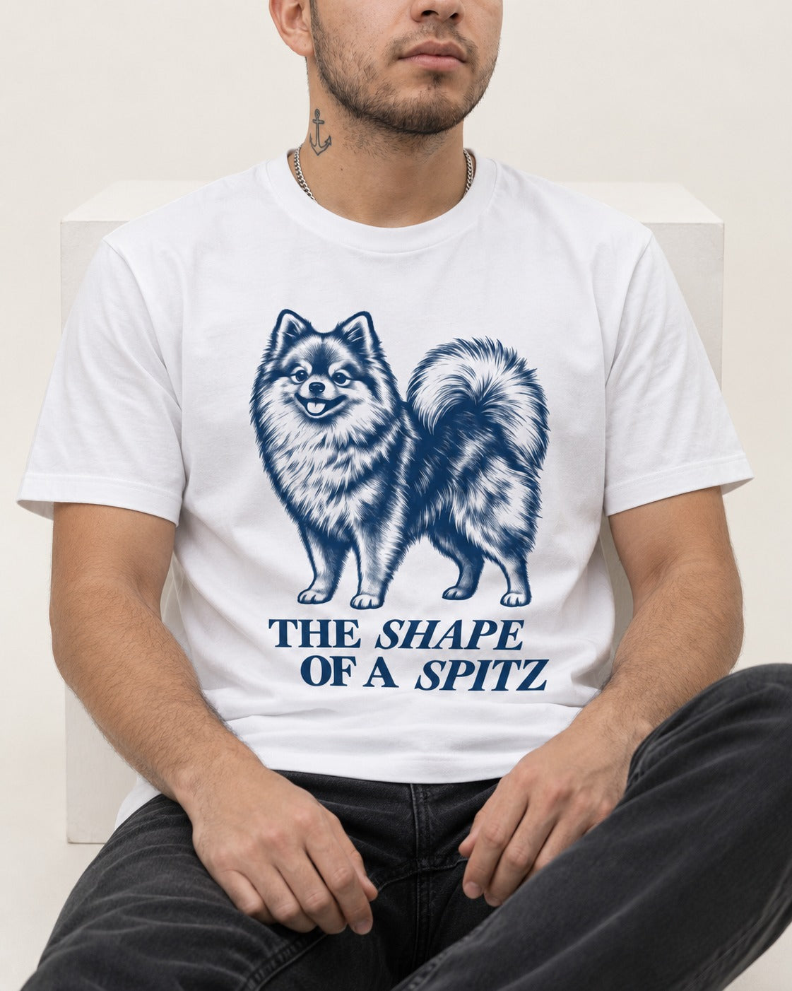 The Shape of a Pomeranian T-Shirt in White, worn by a seated model