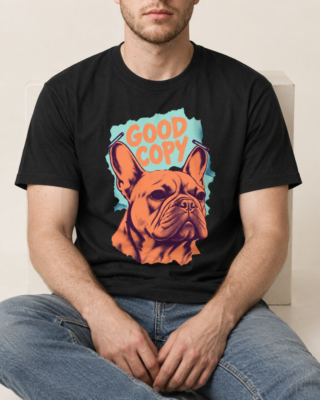 Frenchie Good Copy Stapled Zine Graphic T-Shirt in Black, worn by a seated model
