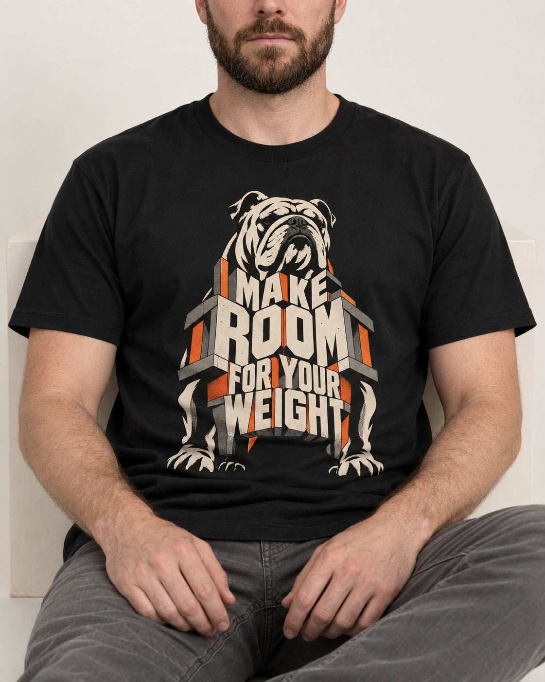 English Bulldog Make Room for Your Weight Dimensional Typography T-Shirt in Black, worn by a seated model