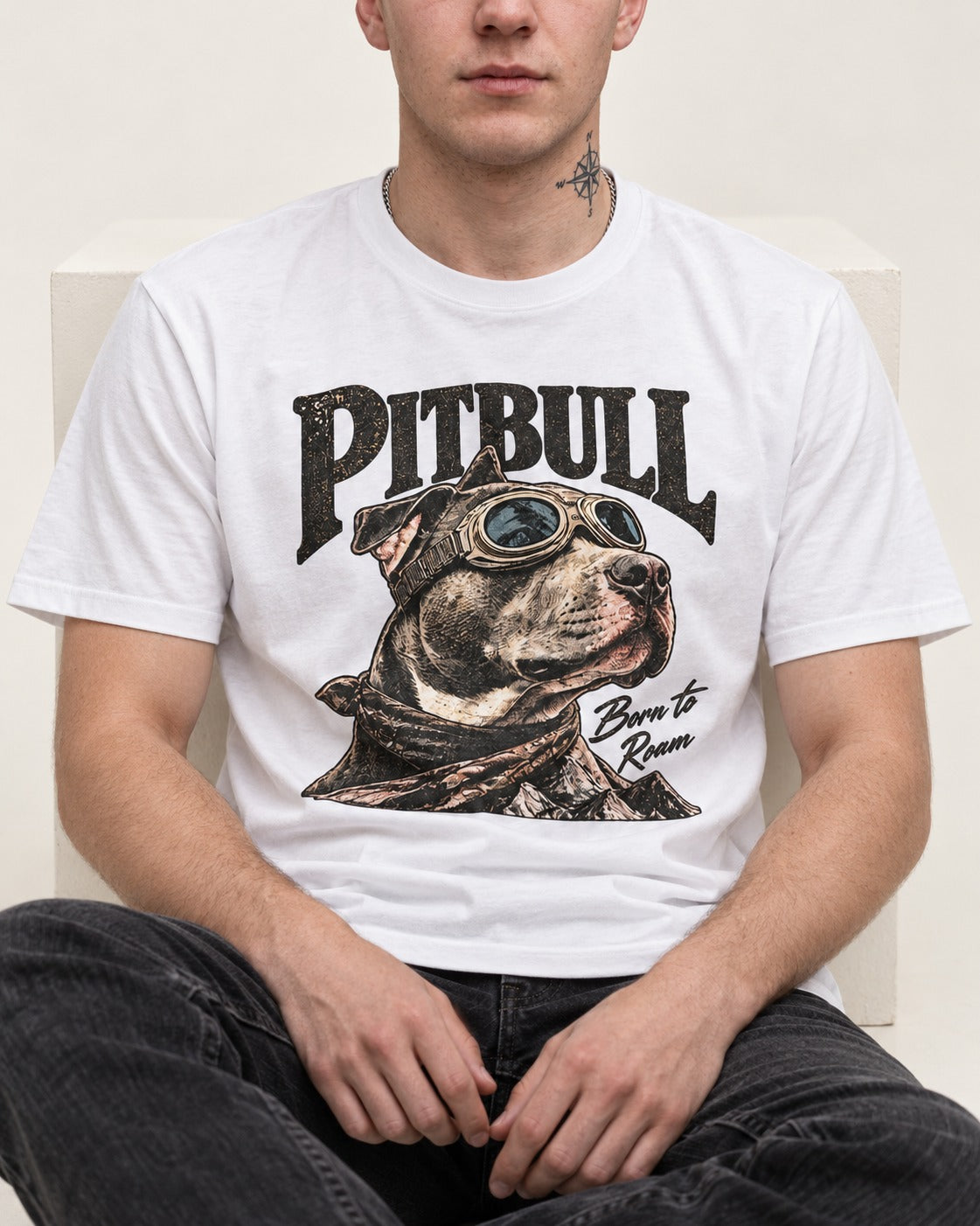 Pitbull Born to Roam T-Shirt in White, worn by a seated model