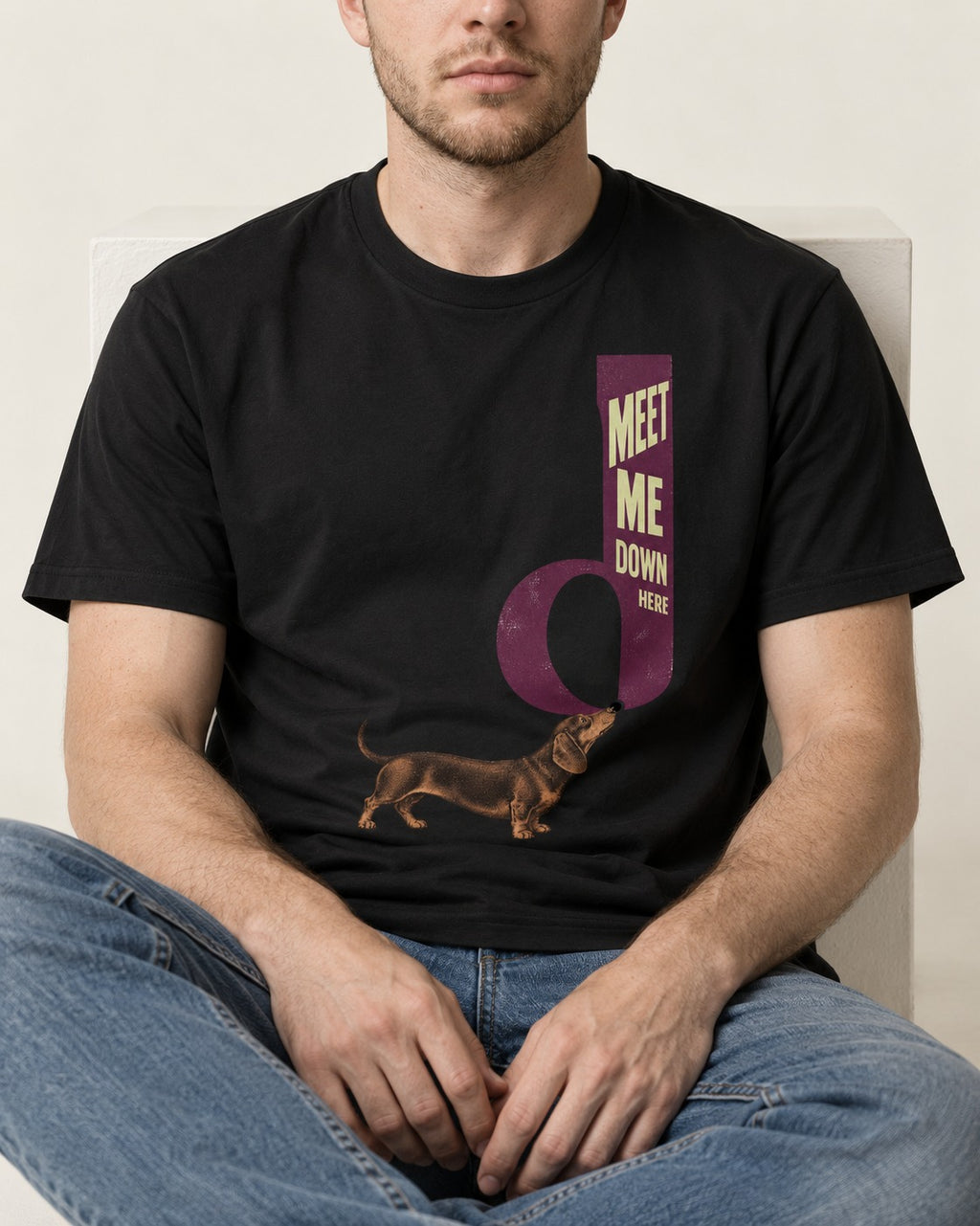 Dachshund Meet Me Down Here Letterform Loop Graphic T-Shirt in Black, worn by a seated model