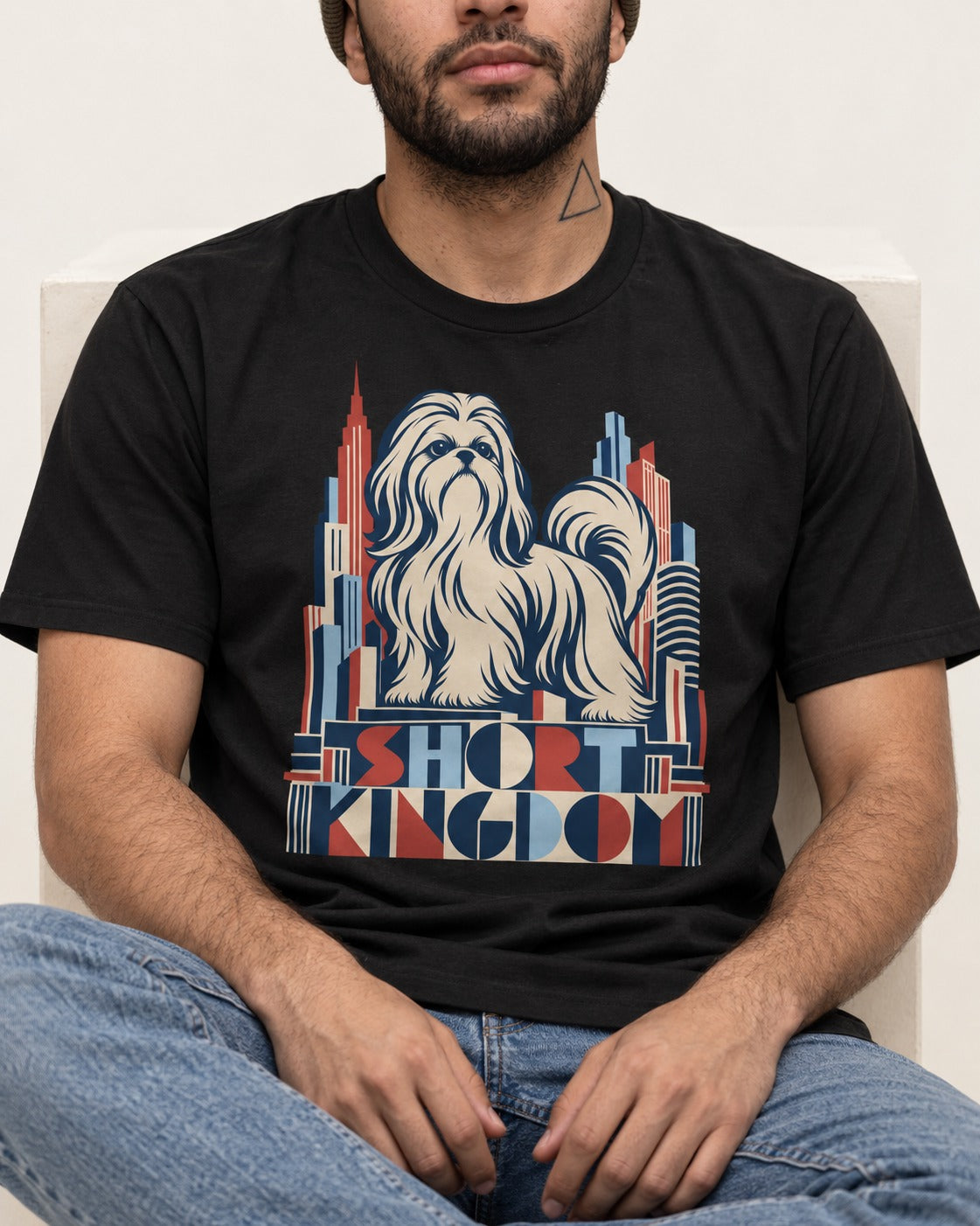 Shih Tzu Short Kingdom Art Deco Skyline Graphic T-Shirt in Black, worn by a seated model