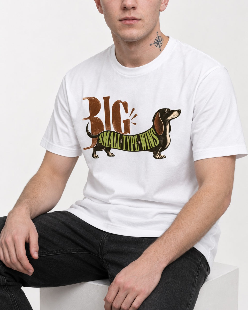 Dachshund Small Type Wins T-Shirt in White, worn by a seated model