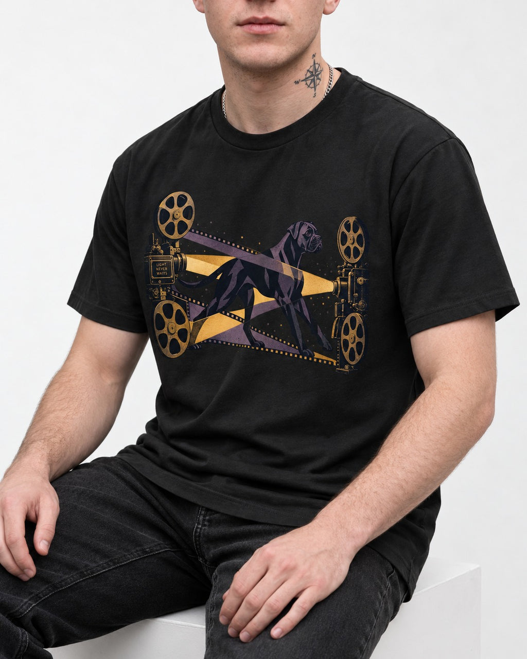 Light Never Waits Boxer Cinema Graphic T-Shirt in Black, worn by a seated model
