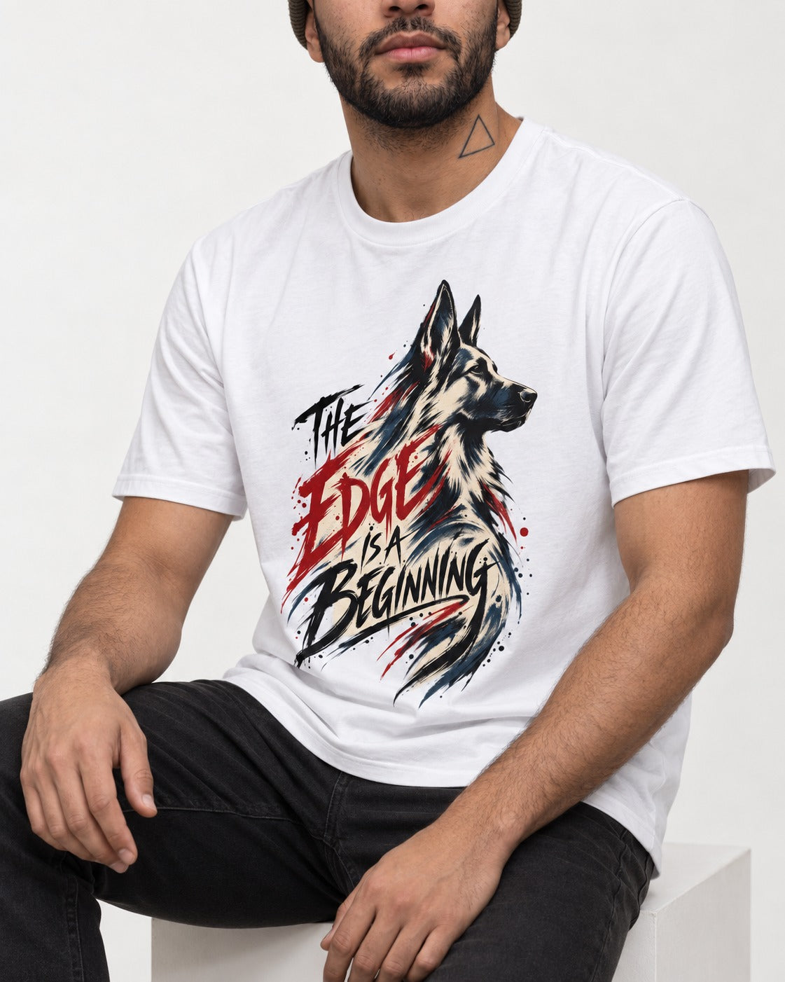 Edge Is a Beginning German Shepherd Dog T-Shirt in White, worn by a seated model
